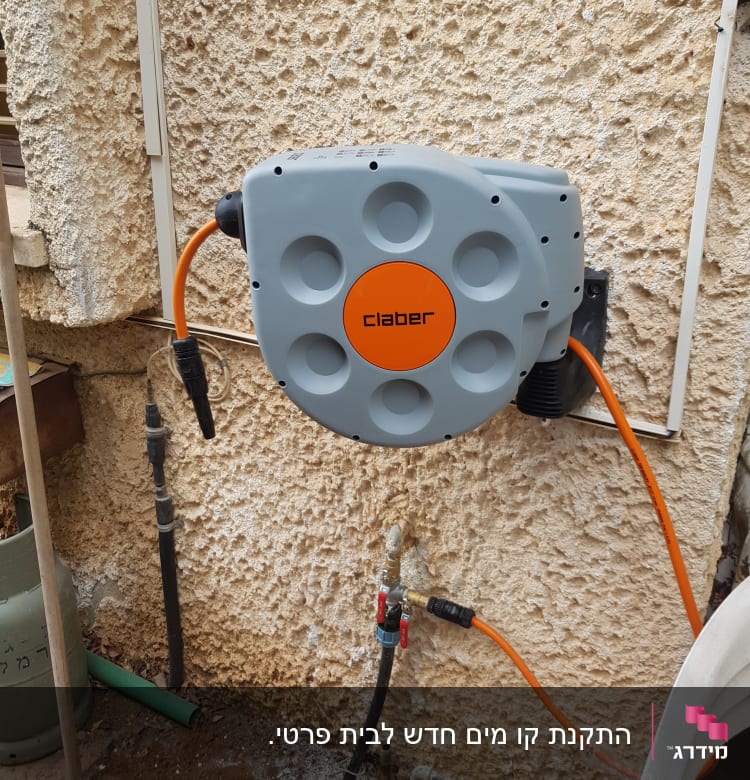 צינור מים כתום מחובר לקיר עם ברזים
